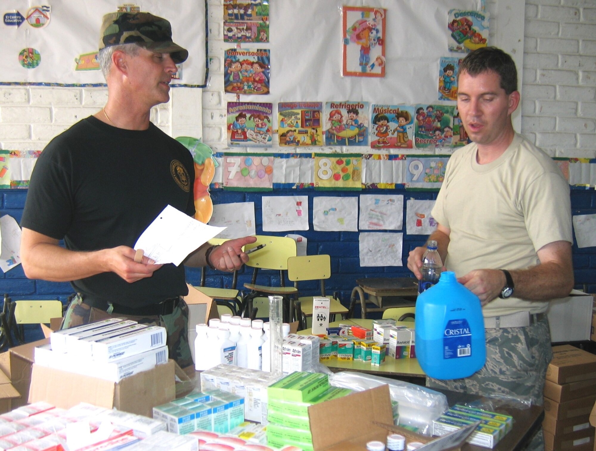 Colonel Rowe and Major Eric Flake serve as pharmacy technicians as they prepare medications for distribution to patients.  (U.S. Air Force photo by Capt. (Dr.) Stephen Potter)

