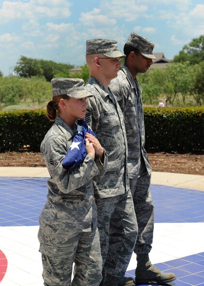 DYESS AIR FORCE BASE, Texas – Dyess Honor Guard members Airman First Class Tera Defrias (left), Master Sgt. Robert Fournier (center) and Staff Sgt. Raul Gonzalez (right) retire the colors during a retreat ceremony July 2 at the Dyess parade grounds here. A retreat ceremony signifies the end of a duty day; and in this special circumstance pays tribute to the Fourth of July holiday and celebrates our countries’ independence. (U.S. Air Force photo by Senior Airman Jennifer Romig)