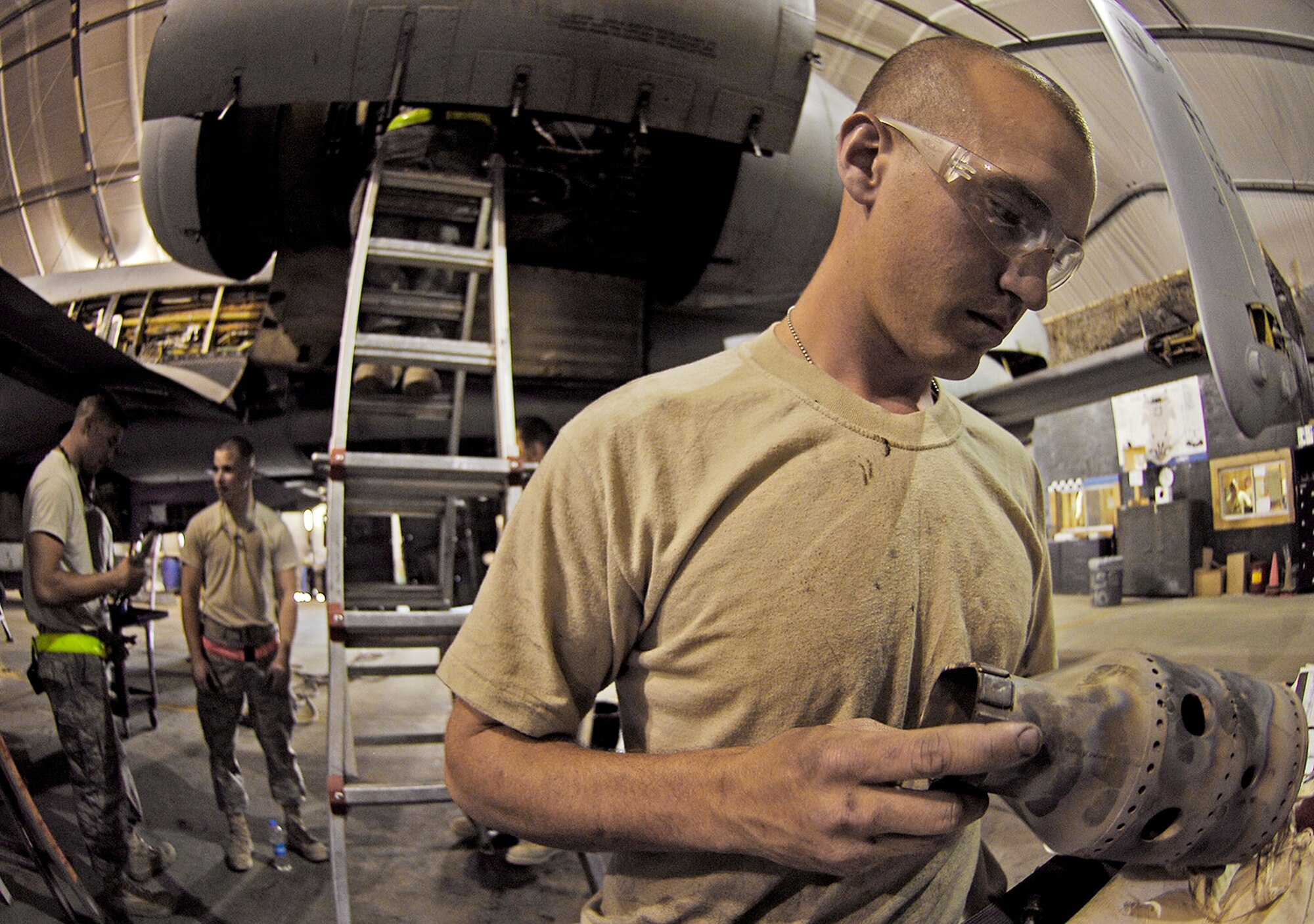 Staff Sgt. Brad Rackley inspects an A-10 Thunderbolt II auxiliary power unit combustion canister during a phase inspection July 2 at Bagram Airfield, Afghanistan. Maintainers here implemented a new phase inspection process that cuts maintenance time on the aircraft in half and ensures the aircraft can provide close-air support for ground troops in Afghanistan. Sergeant Rackley is a 455th Aircraft Maintenance Squadron engine inspection technician. (U.S. Air Force photo/Staff Sgt. Jason Lake) 
