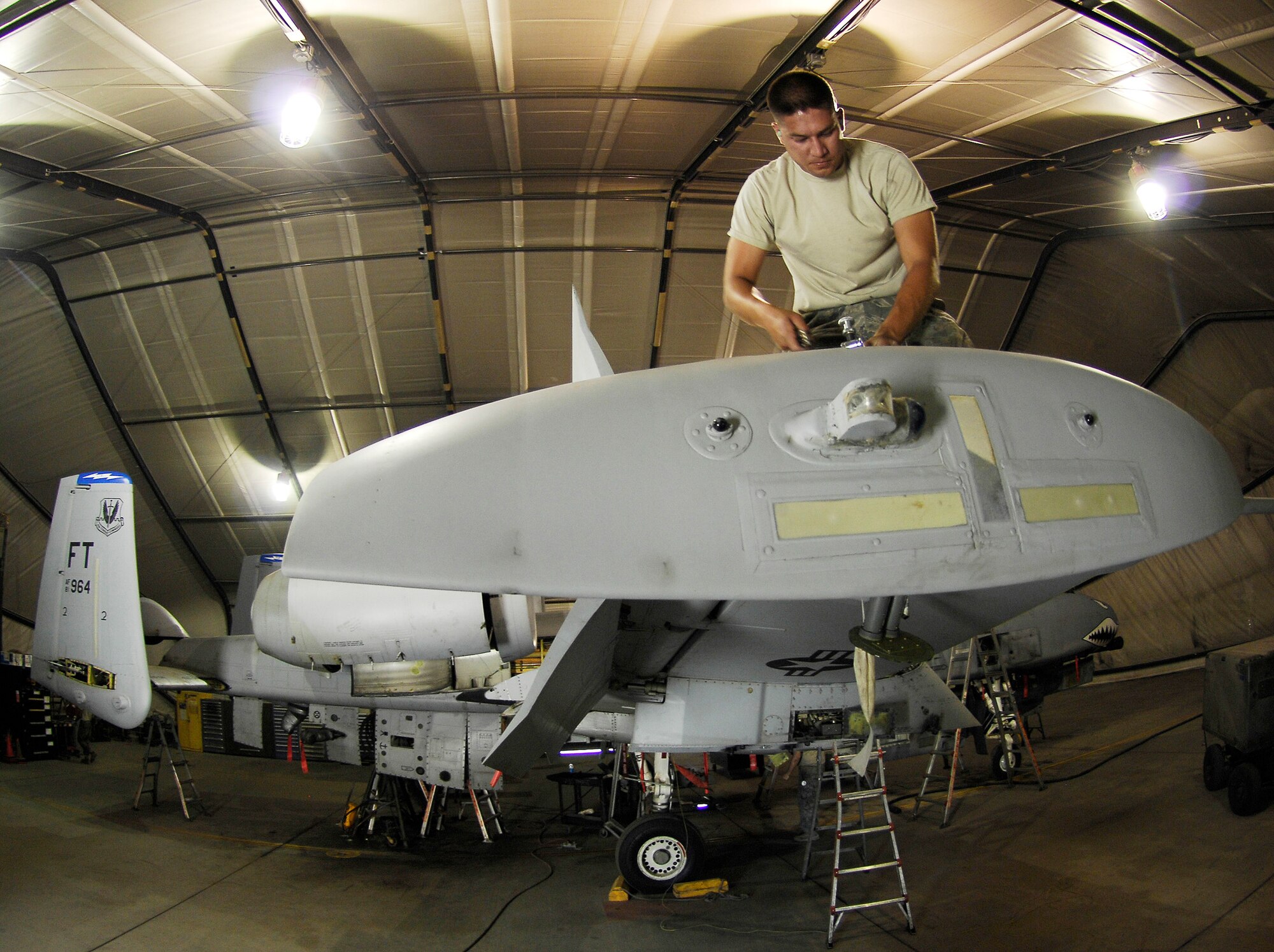 Staff Sgt. James Cole removes screws from an inspection panel during a phase inspection on the A-10 Thunderbolt II July 2 at Bagram Airfield, Afghanistan. Maintainers here implemented a new phase inspection process that cuts maintenance time on the aircraft in half and ensures the aircraft can provide close-air support for ground troops in Afghanistan. Sergeant Cole is a 455th Expeditionary Maintenance Squadron structures technician. (U.S. Air Force photo/Staff Sgt. Jason Lake) 