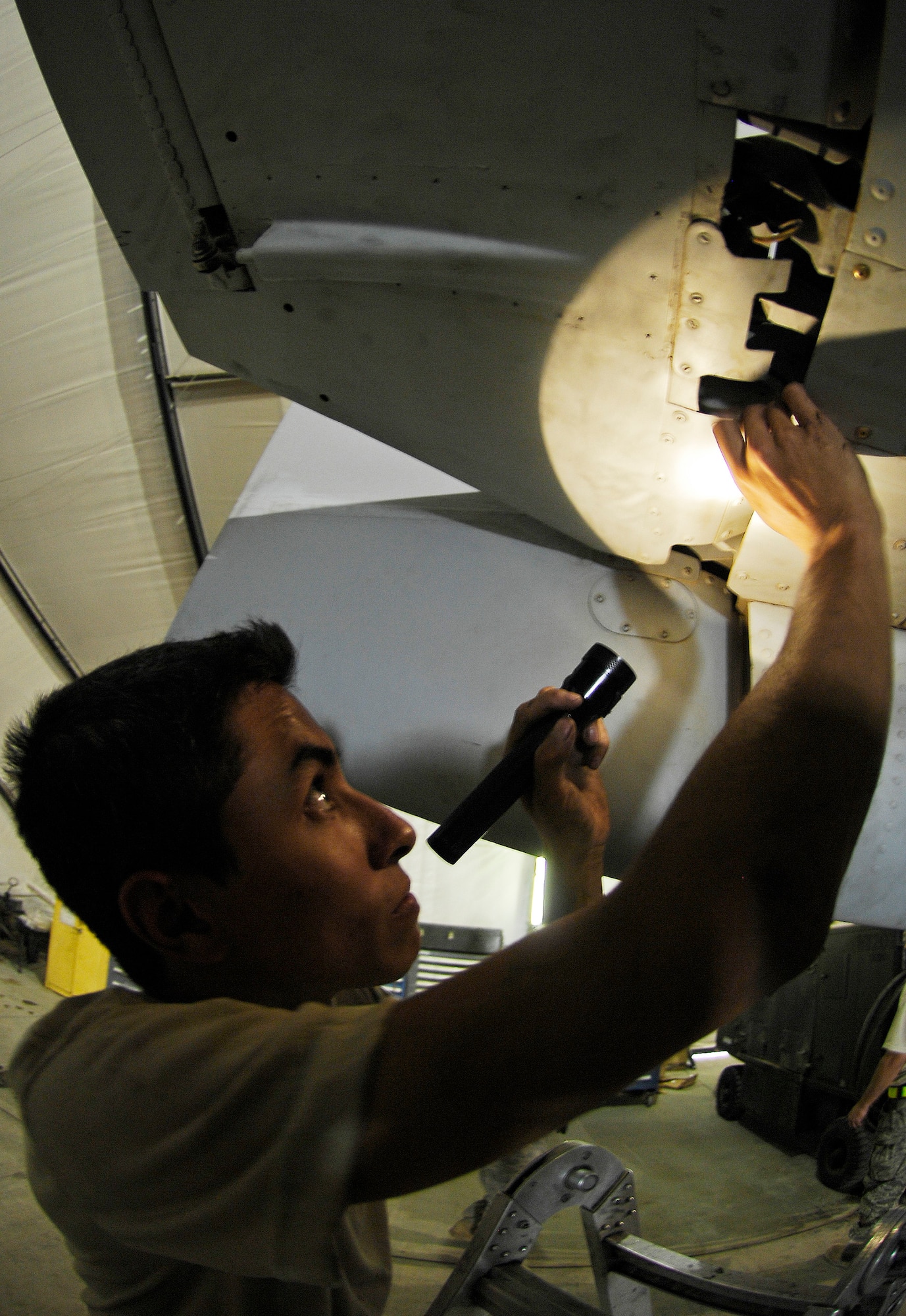 Airman 1st Class Felipe Madriaga inspects an A-10 Thunderbolt II elevator bushing during a phase inspection July 2 at Bagram Airfield, Afghanistan. Maintainers here implemented a new phase inspection process that cuts maintenance time on the aircraft in half and ensures the aircraft can provide close-air support for ground troops in Afghanistan. Airman Madriaga is a 455th Expeditionary Maintenance Squadron phase inspection technician. (U.S. Air Force photo/Staff Sgt. Jason Lake) 
