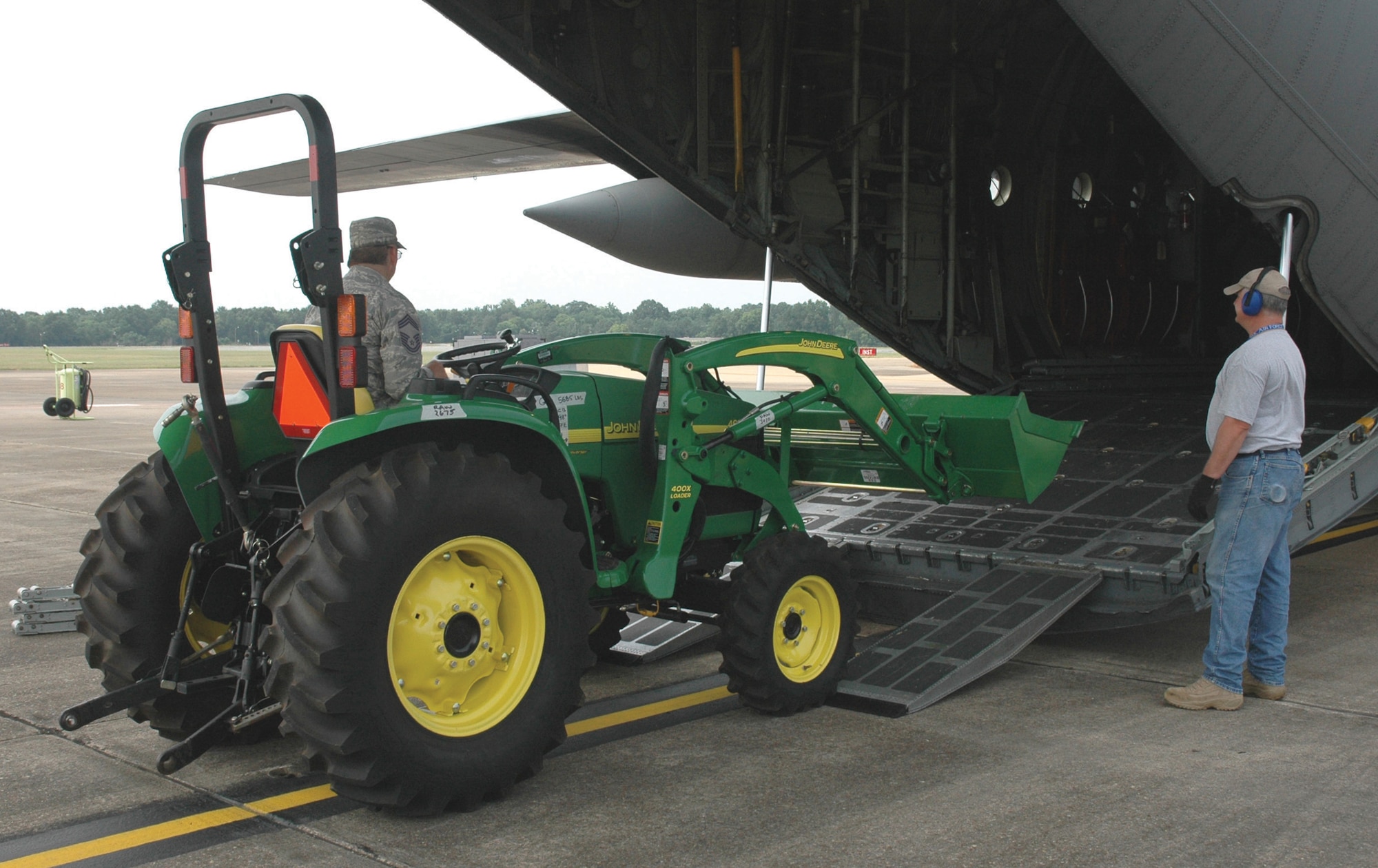 Chief Master Sgt. Lynn Whited drives a tractor into a 908th Airlift Wing C-130 aircraft Monday that is headed for the Dominican Republic. A member of the 908th’s 25th Aerial Port Squadron, Chief Whited loaded the tractor and several other items acquired by Daystar Baptist Missions to be used for humanitarian relief in the Dominican Republic. Lt. Col. Jerry Lobb, 908th public affairs officer, said the cargo was being flown “space available” in accordance with the 1985 Denton Amendment, named after U.S. Sen. Jeremiah A. Denton of Alabama. The Denton Amendment allows nonprofit, charitable organizations access to unused cargo space on Air Force aircraft for humanitarian aid, Colonel Lobb said. He added transportation of the cargo is a “by-product” of mission training. (U.S. Air Force photo/Lt. Col. Jerry Lobb)