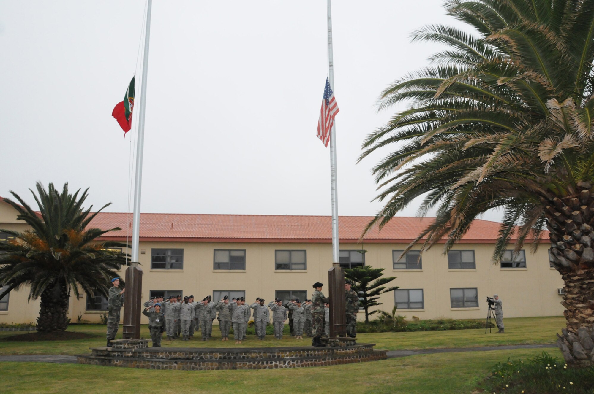 Members of the 65th Security Forces Squadron, at Lajes Field, salute as the American and Portuguese flags are flown half staff in honor of Senior Airman Amber Finell, 65th Security Forces Squadron, at Lajes Field, July 2.  Airman Finnell is from East Tawas, Mich. and entered the Air Force in Feb. 2004.  She had been previously stationed at Minot AFB, N.D. and Sather AB, Baghdad, Iraq; she passed away on June 30, 2009.  (U.S. Air Force photo by Tech Sgt. Rebecca F. Corey)