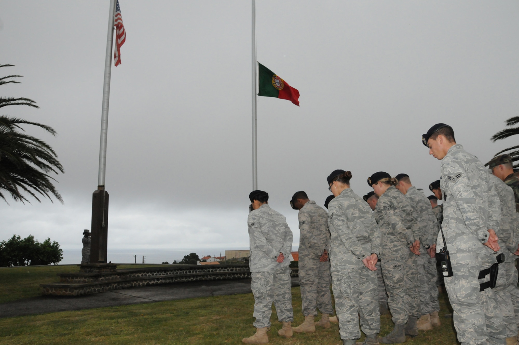 Members of the 65th Security Forces Squadron, at Lajes Field, observe a moment of silence as the American and Portuguese flags are flown half staff in honor of Senior Airman Amber Finell, 65th Security Forces Squadron, at Lajes Field, July 2.  Airman Finnell is from East Tawas, Mich. and entered the Air Force in Feb. 2004.  She had been previously stationed at Minot AFB, N.D. and Sather AB, Baghdad, Iraq; she passed away on June 30, 2009.  (U.S. Air Force photo by Tech Sgt. Rebecca F. Corey)