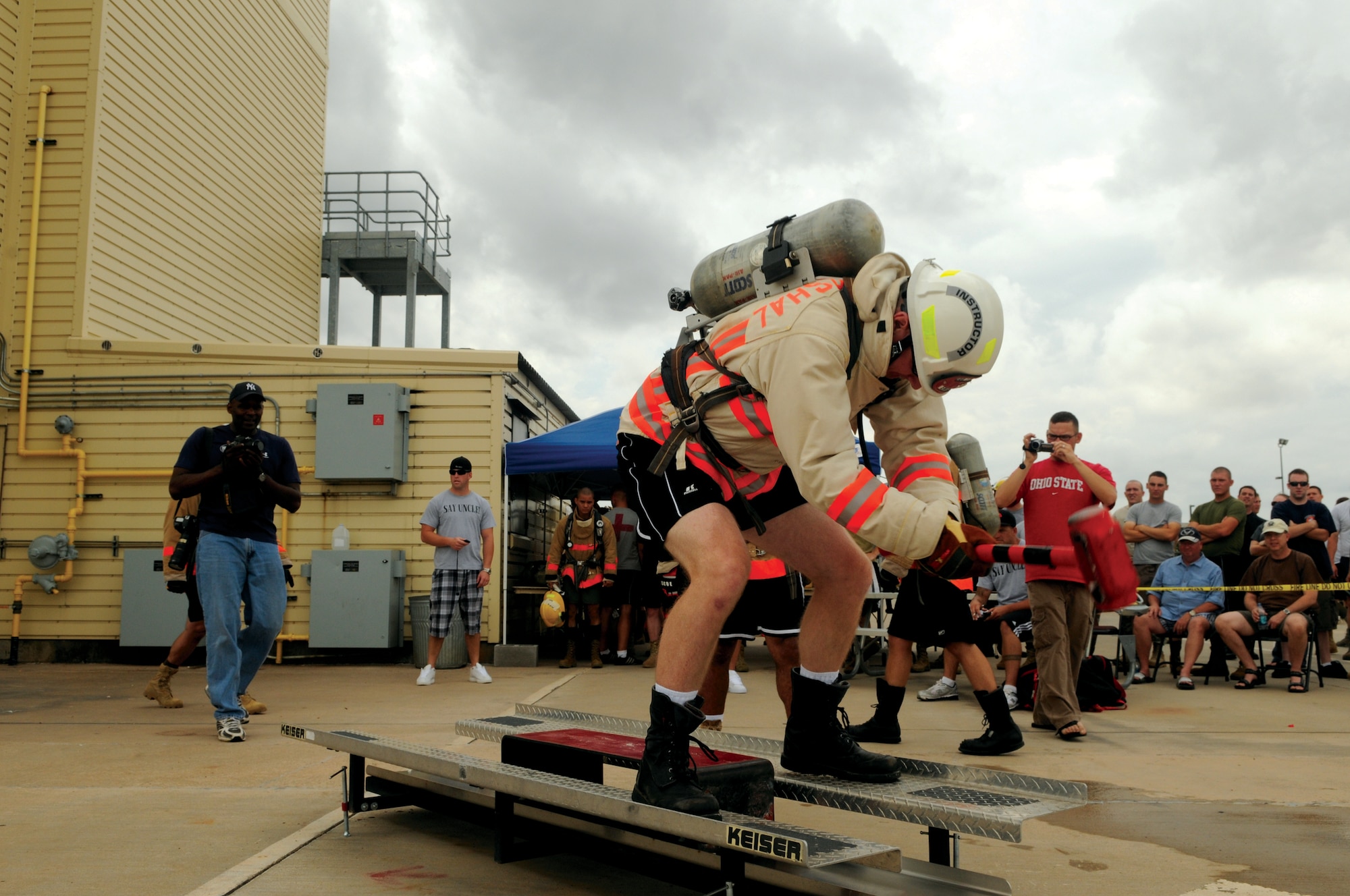 Lieutenant Colonel Shawn Moore, former commander 312th Training Squadron, slams a mallet into the 150-pound block he is required to move during part three of the Rookie Firefighter Combat Challenge June 20. (U.S. Air Force photo by Tech. Sgt. John Barton)