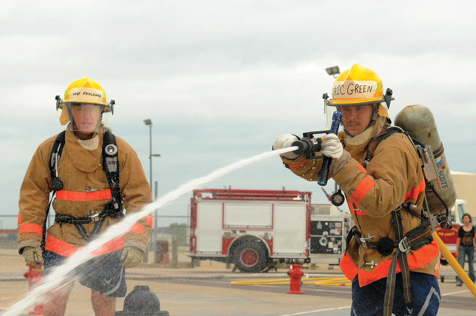 Airman 1st Class Zackary Green, a student at the Louis F. Garland Fire Academy, drags a charged two-thirds inch hose during the fifth stage of the Rookie Firefighter Combat Challenge June 20. (U.S. Air Force photo by Tech. Sgt. John Barton)