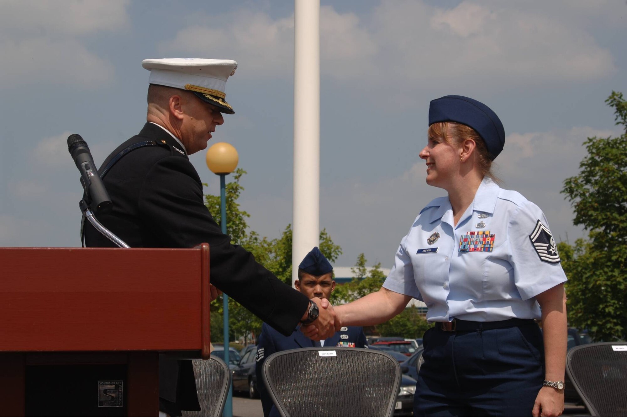 Air Force Senior Master Sergeant Mary A. Bechdel, is congratulated on her selection as one of the 12 Outstanding Airmen of the Year by Marine Corps Colonel Pete Devlin, Commander of the JIOCEUR Analytic Center (JAC) at Royal Air Force Molesworth.  Senior Master Sergeant Bechdel has recently joined the JAC as the Superintendent of the Intelligence Directorate (U.S. Air Force Photo by SSgt Chad E. Chisholm)