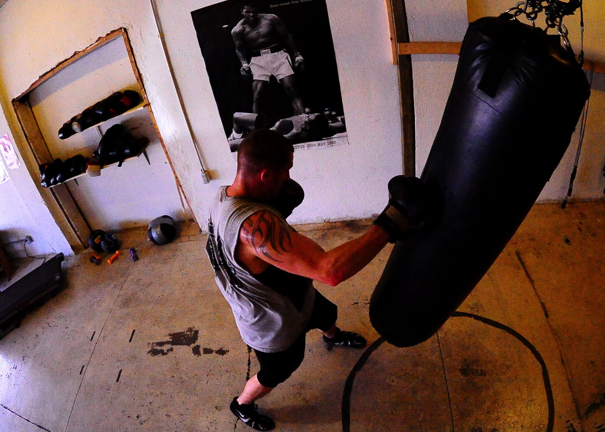 DYESS AIR FORCE BASE, Texas -- Senior Airman Kyle Jenkins, 317th Aircraft Maintenance Squadron instrument flight apprentice, jabs the bag during his rigorous training program June 24 at the Abilene Boxing Club. Airman Jenkins’ main aspiration is to make the Air Force Boxing Team. (U.S. Air Force Photo by Airman 1st Class Stephen Reyes)