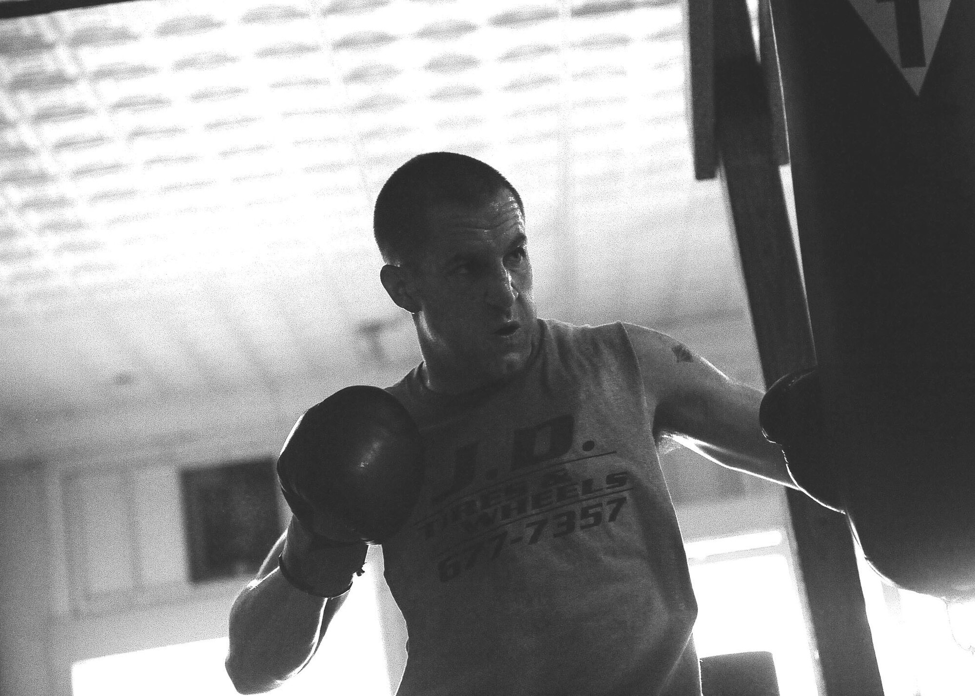 DYESS AIR FORCE BASE, Texas -- Senior Airman Kyle Jenkins, 317th Aircraft Maintenance Squadron instrument flight apprentice, strikes fast June 24 during his rigorous training program at the Abilene Boxing Club. Airman Jenkins has been boxing for two years and is already an Armed Forces contender. (U.S. Air Force Photo by Airman 1st Class Stephen Reyes)