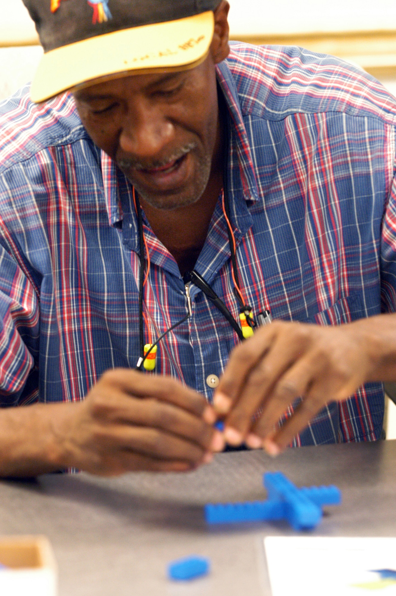 Melvin A. Scott, a C-130 mechanic, concentrates on the task of assembling a lego aircraft  at a training session June 9. U. S. Air Force photo by Sue Sapp