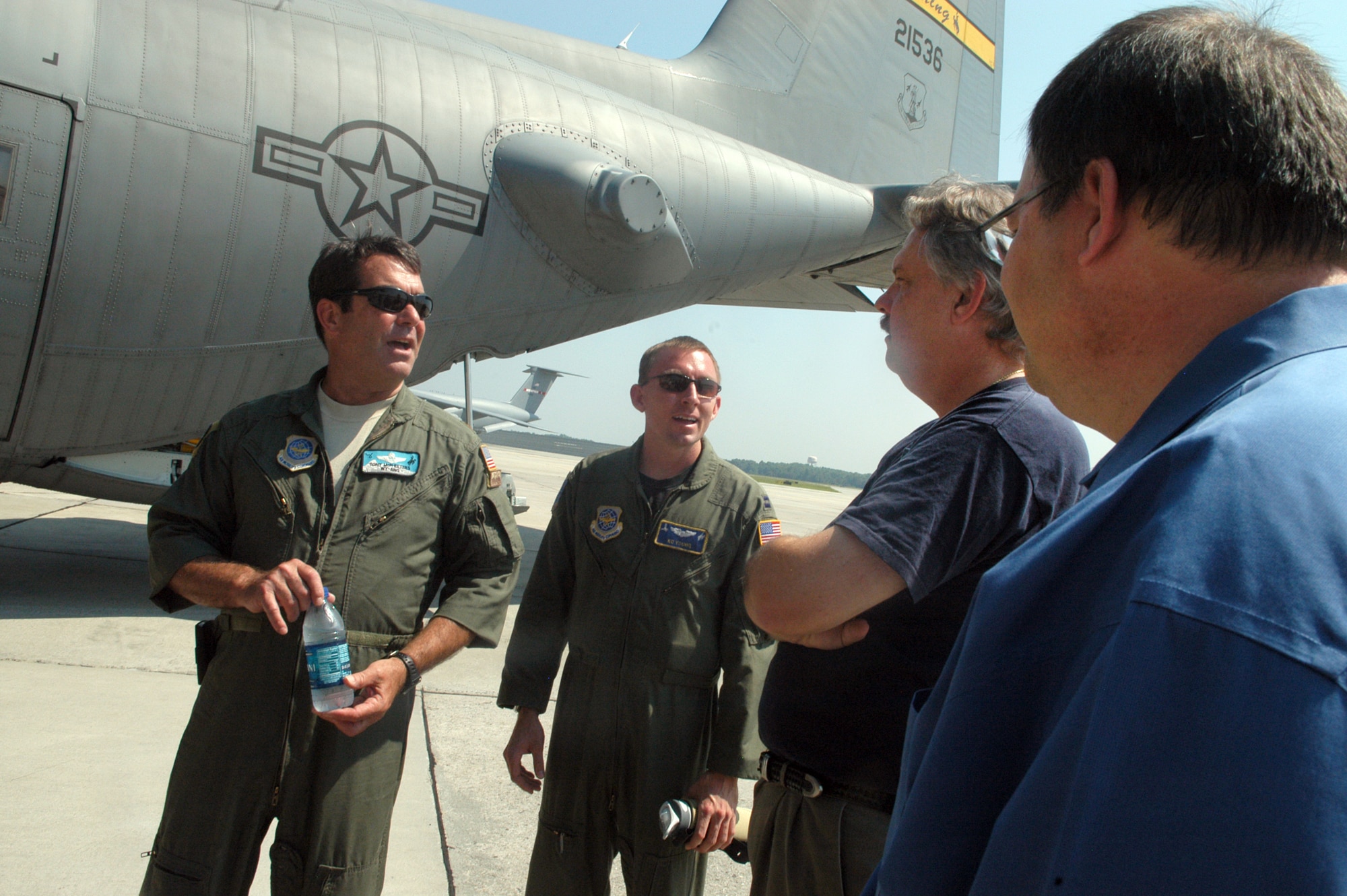 Maj. Tony McPheeters, navigator, and Capt. K. C. Young, pilot, talk with David Richards and Woody Battle, after flying the C-130 H3 into Robins about the advantages of the modification of the propellers on the aircraft. U. S. Air Force photo by Sue Sapp      