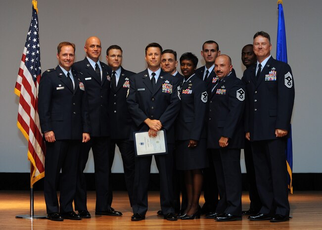 Col. John Wood and Chief Master Sgt. Mike Ivey pose for a group photo with Charleston AFBs newest chief master sergeant, Chief Master Sgt. Robert Frank and the base's first sergeants. Colonel Wood is the 437th Airlift Wing commander, Chief Master Sgt. Ivery is the 437 AW command chief and Chief Master Sgt. Frank is a member of the 437th Aerial Port Squadron. (U.S. Air Force photo/Senior Airman Katie Gieratz)