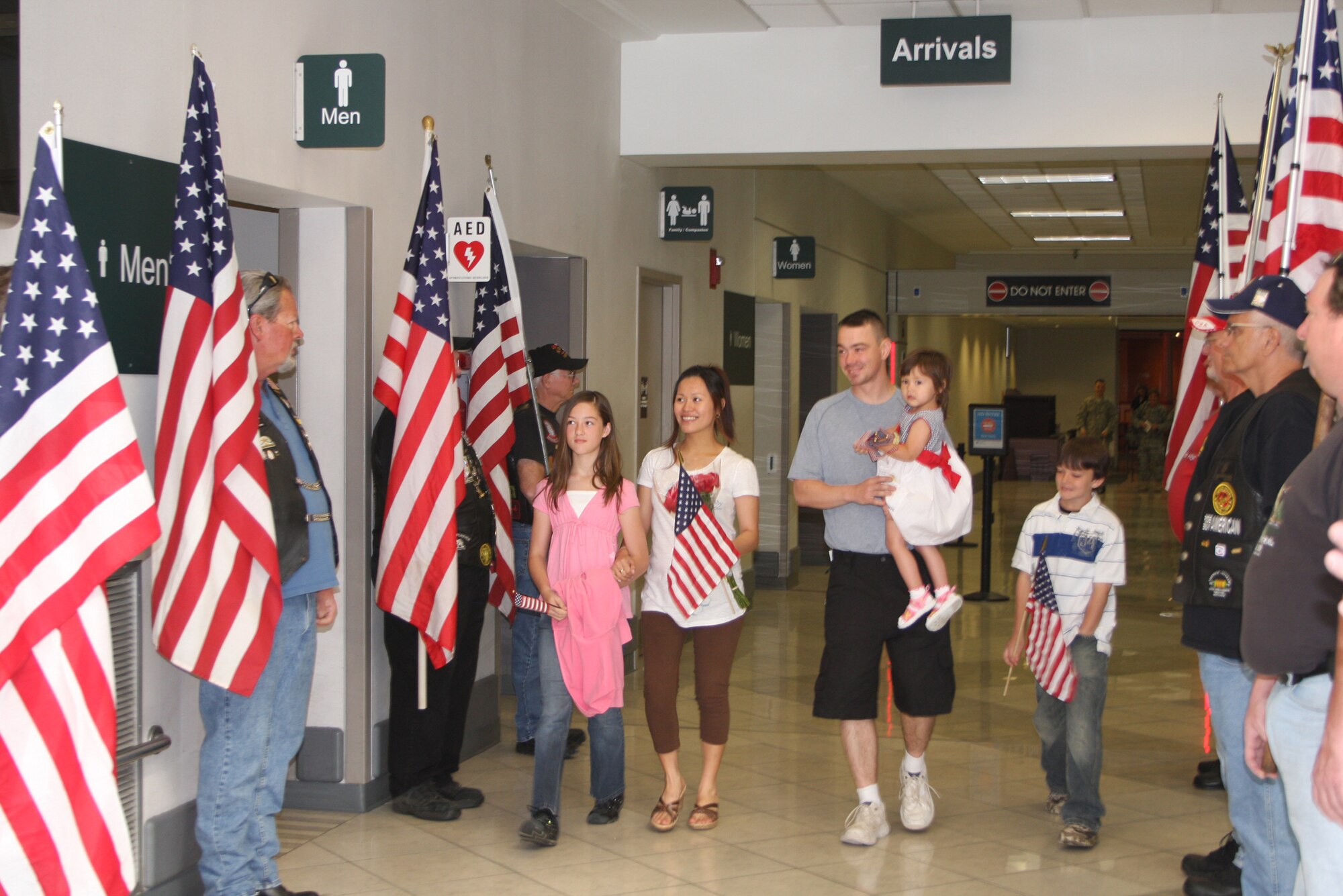WRIGHT-PATTERSON AIR FORCE BASE, Ohio - Tech. Sgt. Greg Shepherd, 445th Security Force Squadron, was greeted at the Dayton International Airport by family, co-workers and Airmen from various organizations at Wright-Patt after returning home May 22 from a deployment in Iraq. The base and community came together to help Sergeant Shepherd and his family after they lost their house and personal affects in a house fire May 18. (Air Force photo/Maj. Cynthia Harris)