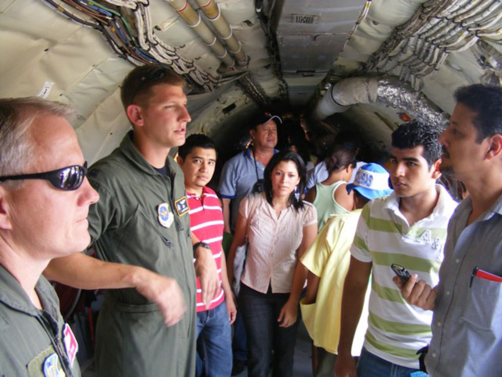 Capt. Isaiah Oppelaar, a pilot deployed here from MacDill Air Force Base, Fla., gives a tour of the KC-135 June 21 during an air show. More than 30 Airmen participated at the international air show June 20-21. The more than $35,000 proceeds from the show will help build a children?s intensive care unit at a local hospital. 