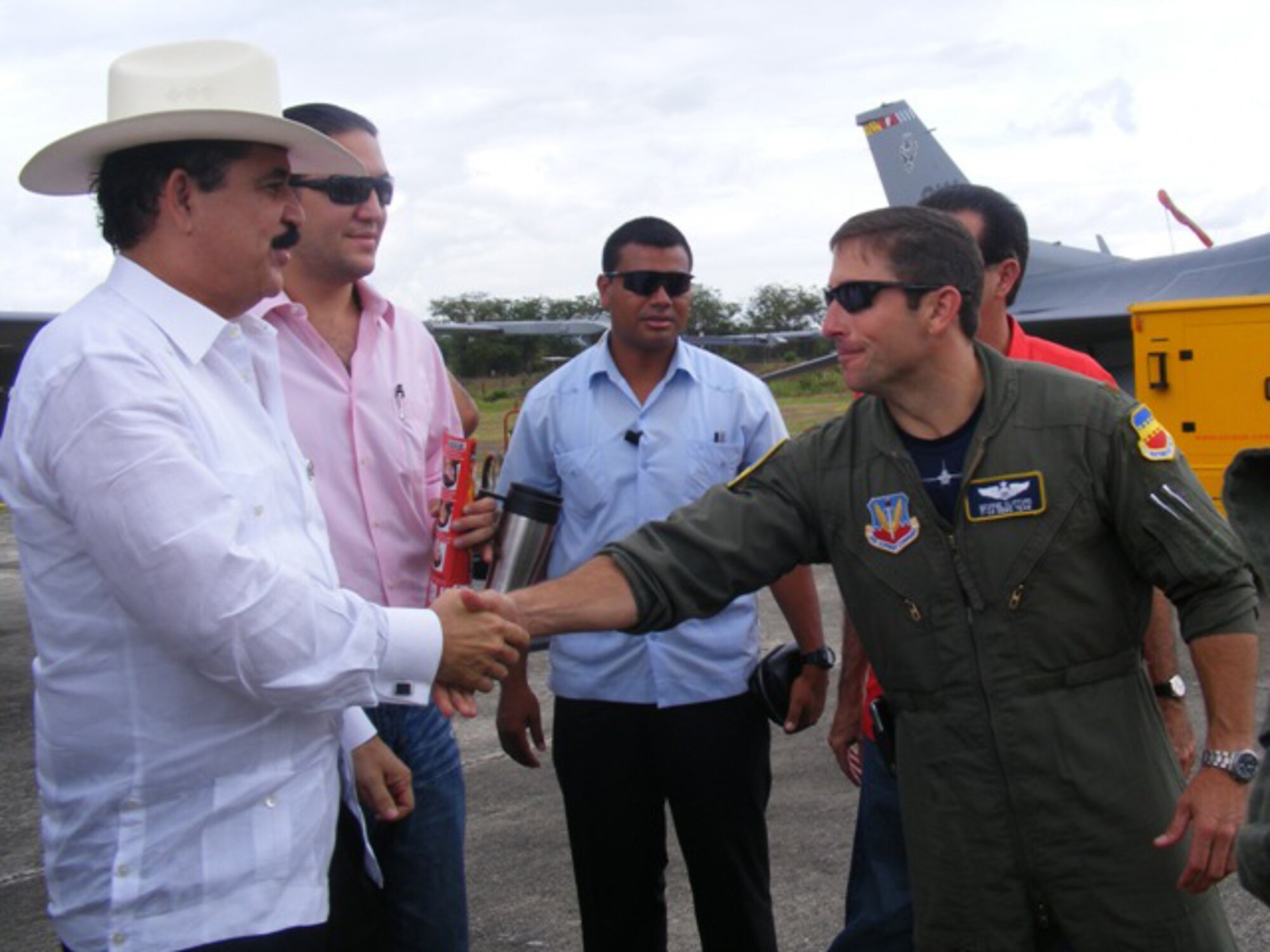 Maj. George Clifford, Viper East F-16 Demo Team pilot, shakes hands with Manuel Zelaya, the president of Honduras, June 20. After receiving a tour of the F-16, the Honduran president thanked the U.S. Air Force for its participation in the international air show June 20-21. The more than $35,000 proceeds from the show will help build a children?s intensive care unit at a local hospital. 