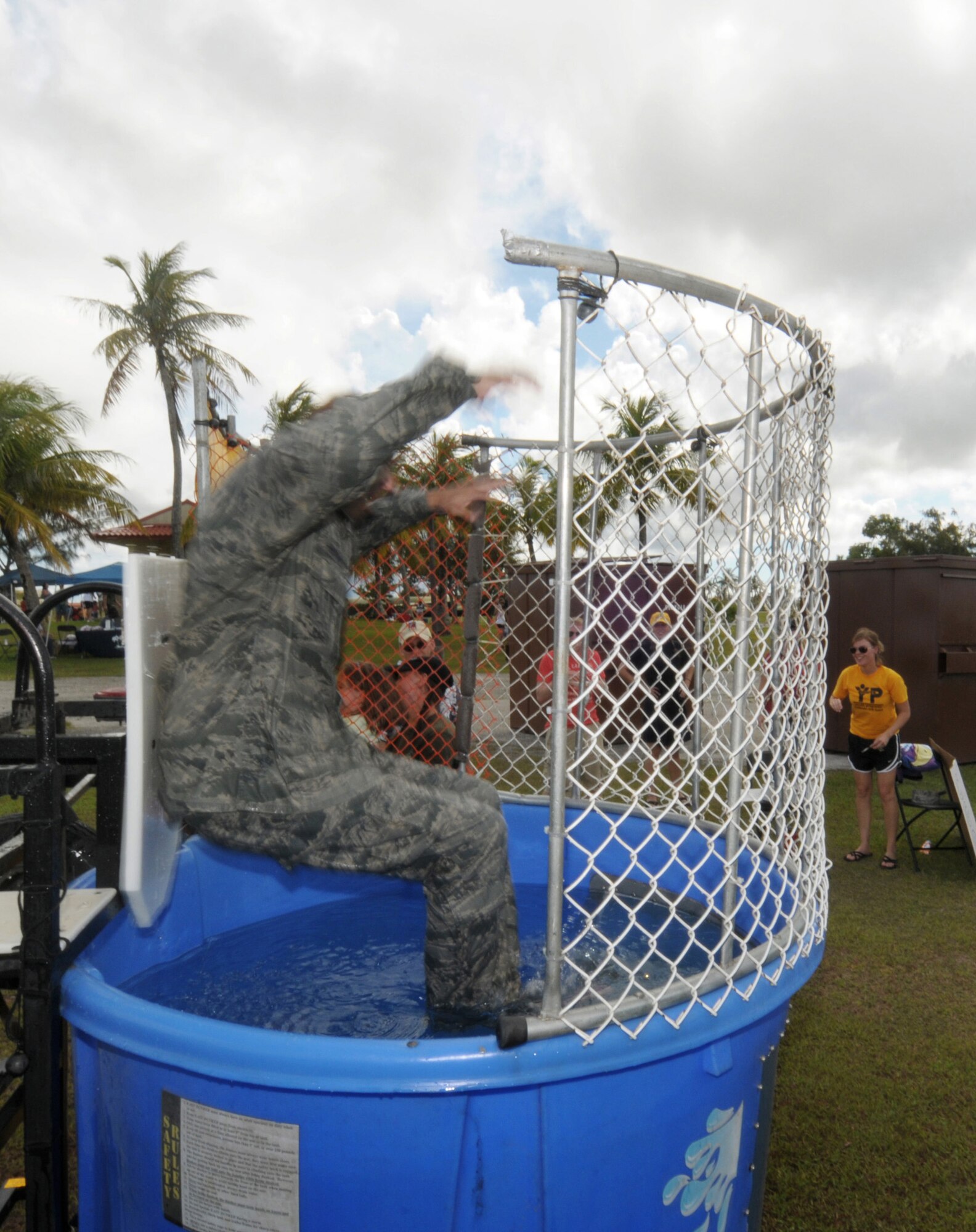 ANDERSEN AIR FORCE BASE, Guam - Lt Col Brian Hinsvark, 36th Force Support Squadron commander, tests the water of the dunking booth, to the enjoyment of the crowd during Andersen's Freedom Fest 2009 here July 2.  Other entertainment included live music, face painting, a water slide, a bouncy castle, horse rides, paintball, pie eating contests and free food. (U.S. Air Force photo by Tech. Sgt. Michael Boquette)