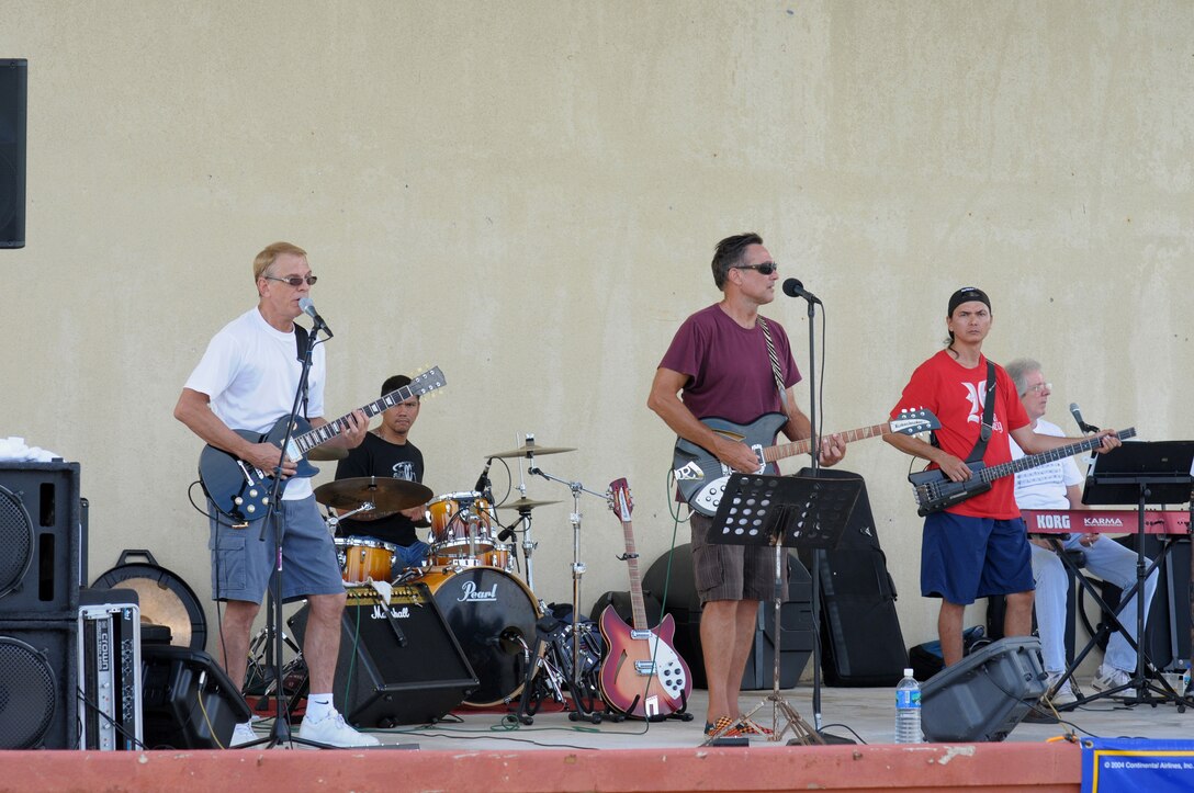 ANDERSEN AIR FORCE BASE, Guam  Live music for the enjoyment of all was provided by  "M-80's" during Andersen's Freedom Fest 2009 here July 2. Activities included face painting, a water slide, a bouncy castle, a dunking booth, paintball, pie eating contests and horse rides. (U.S. Air Force photo by Tech. Sgt. Michael Boquette)