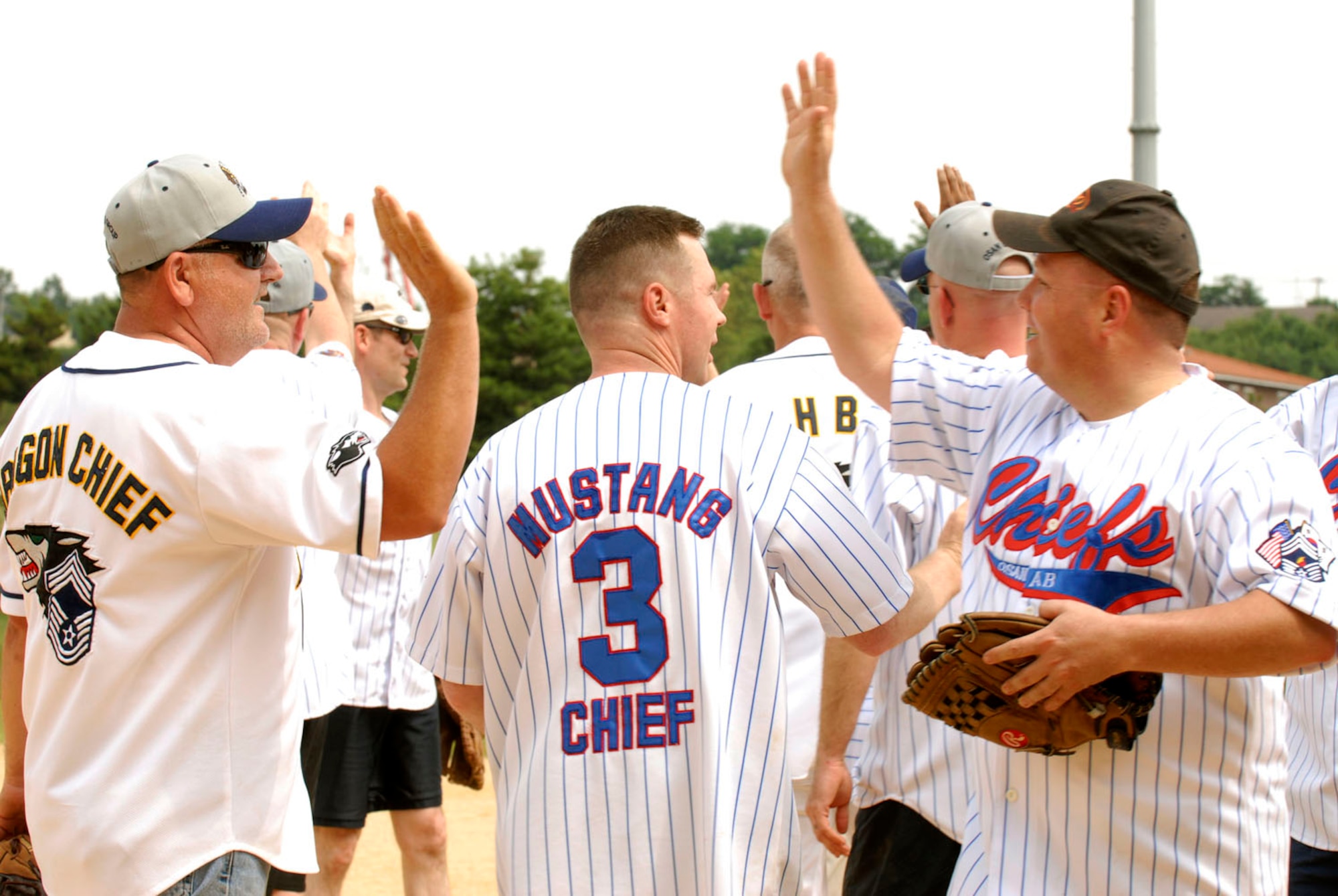 The Osan chiefs high-five the Eagles team letting them know it was a good game after the Chiefs beat them 10-7 in their annual softball tournement July 1 at Osan Air Base, Republic of Korea. (U.S. Photograph by Senior Airman Stephenie Wade)