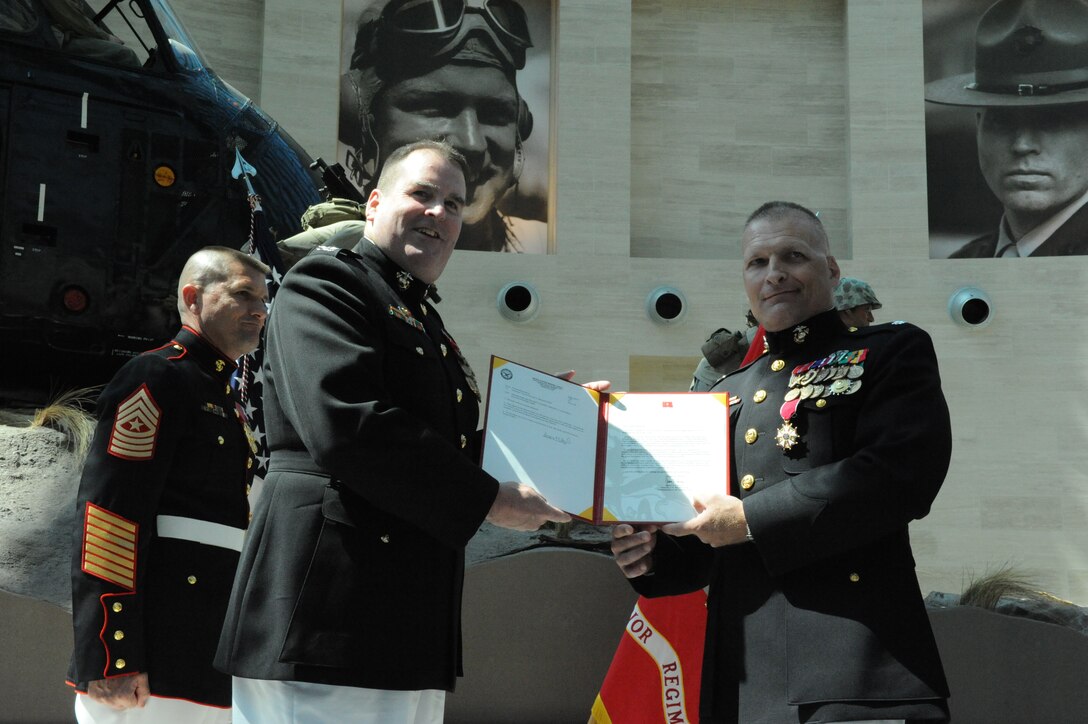Lt. Col. Timothy Maxwell, a founder of the Wounded Warrior Regiment, receives the Legion of Merit for his dedicated service to the Wounded Warrior Regiment, by Col. Daniel P. Kelly, his retiring officer, June 26, 2009, at the National Museum of the Marine Corps, Quantico, Va. U.S. Marine Corps photo by Pfc. Jahn R. Kuiper 
