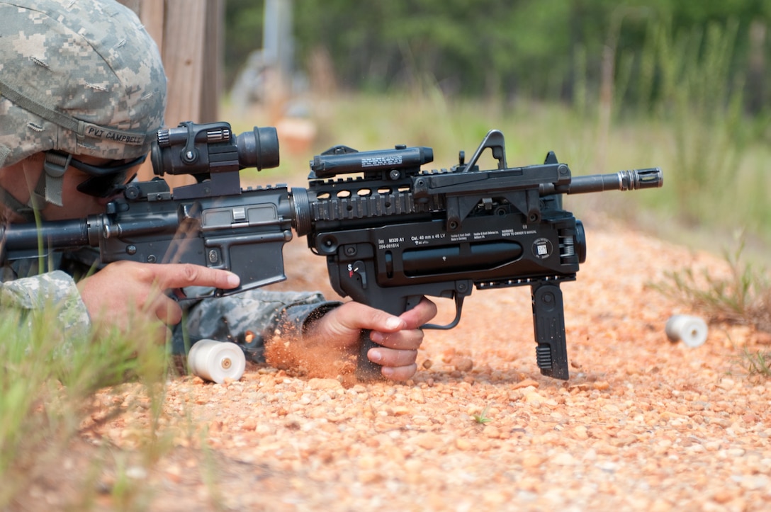 A U.S. Army paratrooper fires a training round from the new M320 grenade launcher while learning to use the weapon on a Fort Bragg, N.C., range, July 1, 2009.