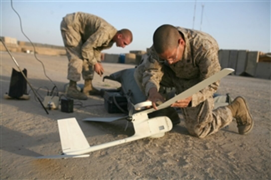 U.S. Marine Corps Lance Cpl. Donald Glover, with Alpha Company, 1st Battalion, 7th Marine Regiment, assembles a RQ-11B Raven unmanned aerial vehicle at Combat Outpost Viking, Iraq, on June 2, 2009.  Marines are test flying the aircraft to obtain company-level surveillance information and intelligence.  