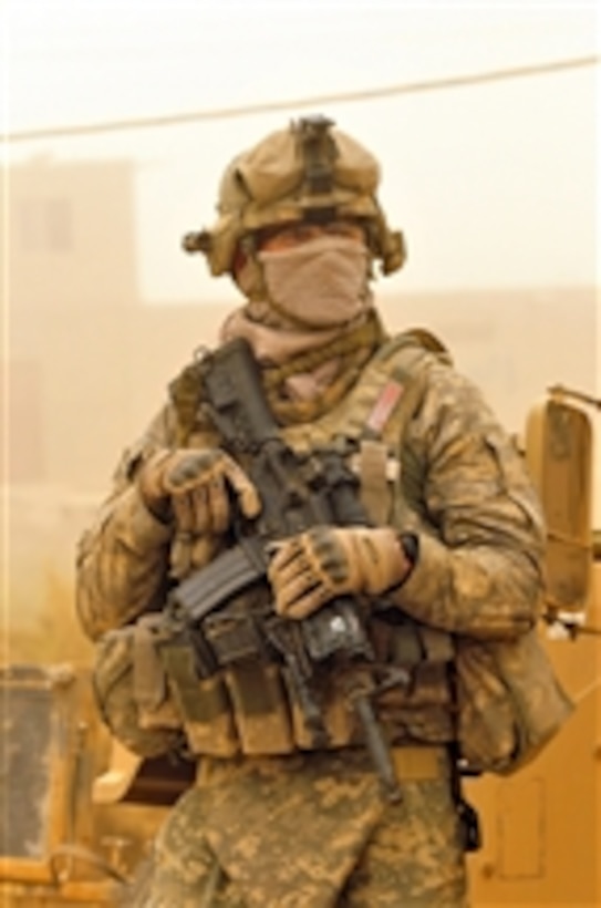 A U.S. Army soldier with 1st Squadron, 150th Cavalry Regiment, 30th Heavy Brigade Combat Team, 1st Cavalry Division wears a mask to protect himself from a dust storm in Baghdad, Iraq, on June 27, 2009.  