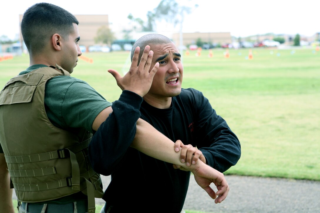 Sgt. Adrian Moreno explains the steps to perfomring a shoulder toss to a Marine Corps Martial Arts Program class July 1. Moreno is the combat conditioner and MCMAP instructor for Marine Wing Headquarters Squadron 3 aboard the air station.