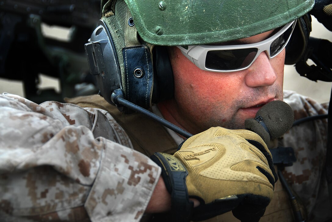 Light-armored vehicle commander Gunnery Sgt. Matthew Vickers, 33, clears his vehicle’s antennae under a tunnel as 1st Light Armored Reconnaissance Battalion conducts the tactical recovery of a simulated missing pilot here July 2. The LAR detachment is part of Battalion Landing Team 2/4, the 11th Marine Expeditionary Unit’s ground combat element. The MEU, part of the Bonhomme Richard Amphibious Ready Group, is conducting its first pre-deployment exercise at sea with its Navy counterpart, Amphibious Squadron 7. The Navy and Marine Corps team is testing interoperability before a deployment certification exercise later this summer. Vickers hails from Decatur, Ill.