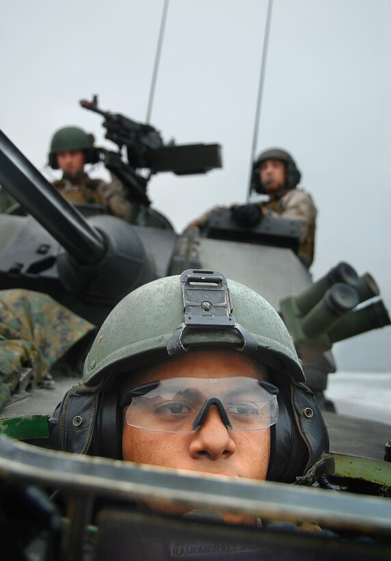 Lance Cpl. Marlo Morales, 20, operates a light-armored vehicle while he and fellow members from 1st Light Armored Reconnaissance Battalion conduct the tactical recovery of a simulated missing pilot here July 2. The LAR detachment is part of Battalion Landing Team 2/4, the 11th Marine Expeditionary Unit’s ground combat element. The MEU, part of the Bonhomme Richard Amphibious Ready Group, is conducting its first pre-deployment exercise at sea with its Navy counterpart, Amphibious Squadron 7. The Navy and Marine Corps team is testing interoperability before a deployment certification exercise later this summer. Morales hails from Downey, Calif.