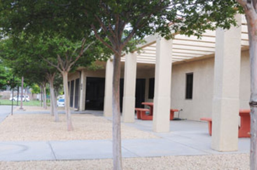 Staff from the Communications Squadron joined civil engineers removing plants and preparing the site to be covered with ‘California Gold’ rock. (U.S. Air Force photo by Ryan Wood)