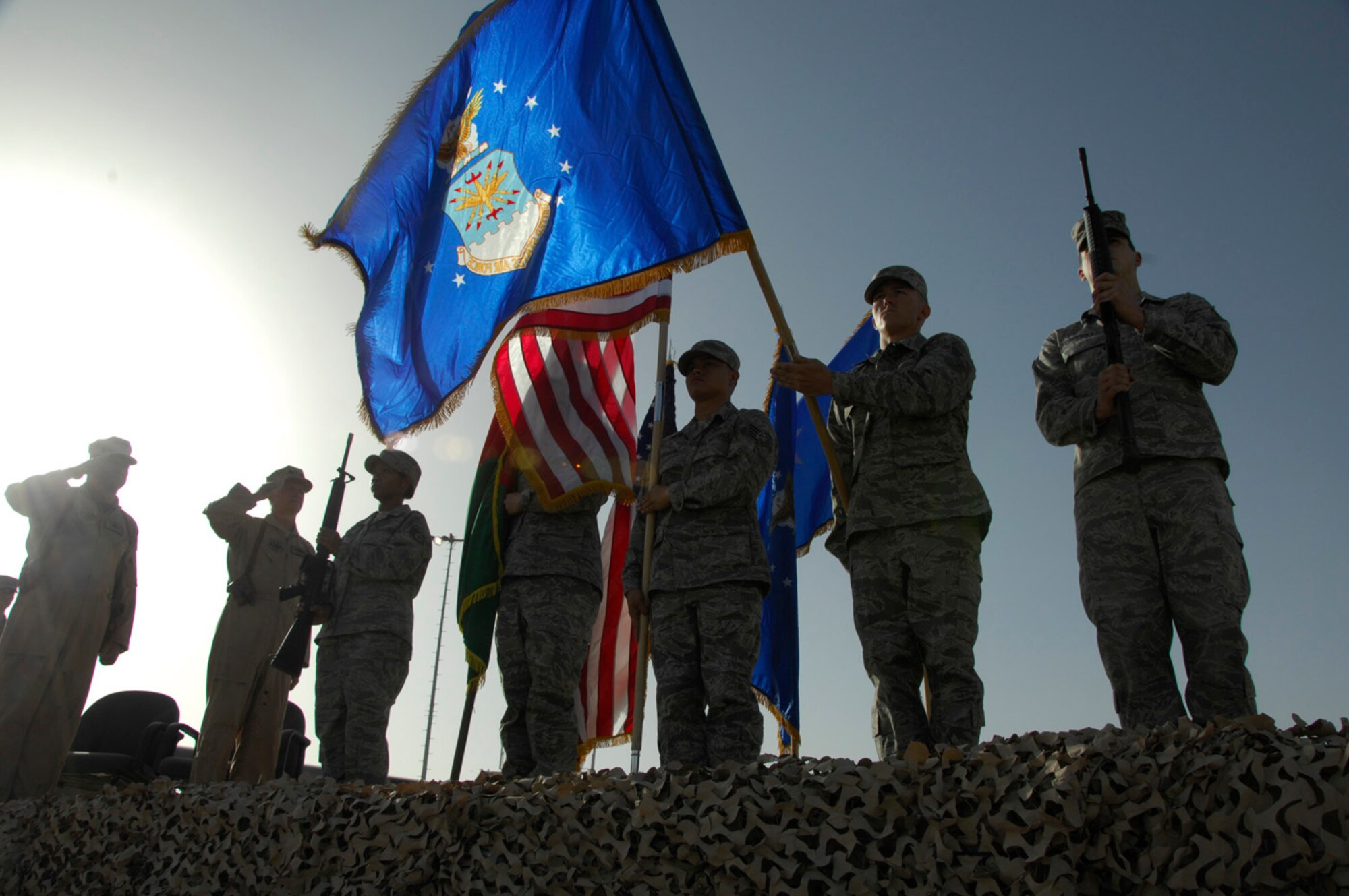 KANDAHAR AIRFIELD, Afghanistan - Lieutenant General Gary L. North, 9th Air Force and Air Forces Central commander (far left) and Brigadier General Guy M. Walsh, the new 451st Air Expeditionary Wing commander (second from left) salute as the Afghanistan and U.S. national anthems are played during an assumption of command and activation ceremony here July 2, 2009.  Unit Airmen, distinguished visitors and coalition partners attended as the 451st transitioned from a group to a wing at 7 a.m. General Walsh was the wing commander for the 175th Wing, Maryland Air National Guard before accepting his assignment here.  (U.S. Air Force photo by 1st Lt. Noelle Caldwell)