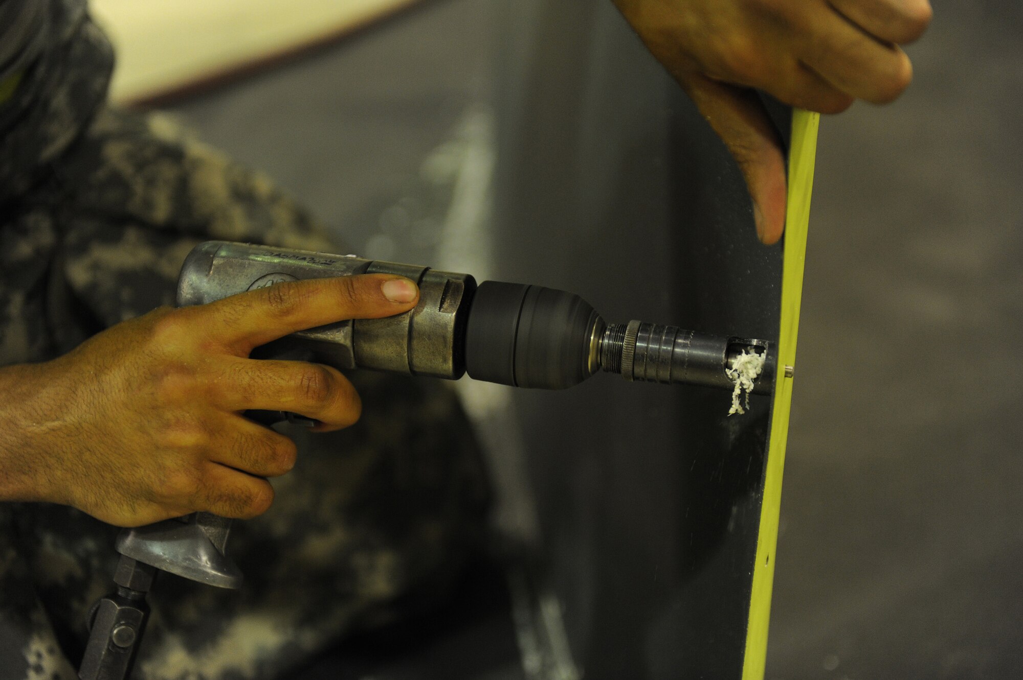 SOUTHWEST ASIA - Staff Sgt. Gary Pitcher, a 380th Expeditionary Maintenance Squadron, aircraft structural maintenance craftsman, drills counter sinking holes on a panel for a KC-10 Extender, June 17 at an undisclosed location in Southwest Asia. The holes will allow the screws to sit flush giving it an aerodynamic surface. (U.S. Air Force photo by Senior Airman Brian J. Ellis) (Released)