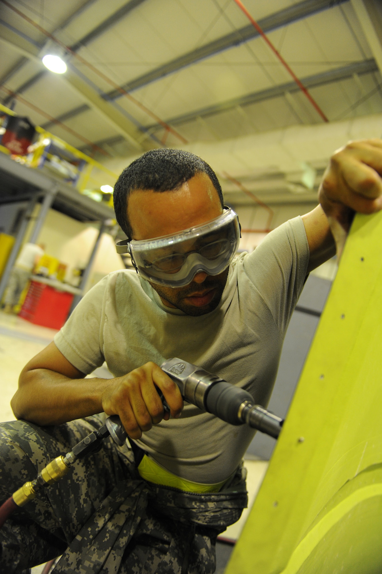SOUTHWEST ASIA - Staff Sgt. Gary Pitcher, a 380th Expeditionary Maintenance Squadron, aircraft structural maintenance craftsman, drills counter sinking holes on a panel for a KC-10 Extender, June 17 at an undisclosed location in Southwest Asia. The holes will allow the screws to sit flush giving it an aerodynamic surface. (U.S. Air Force photo by Senior Airman Brian J. Ellis) (Released)