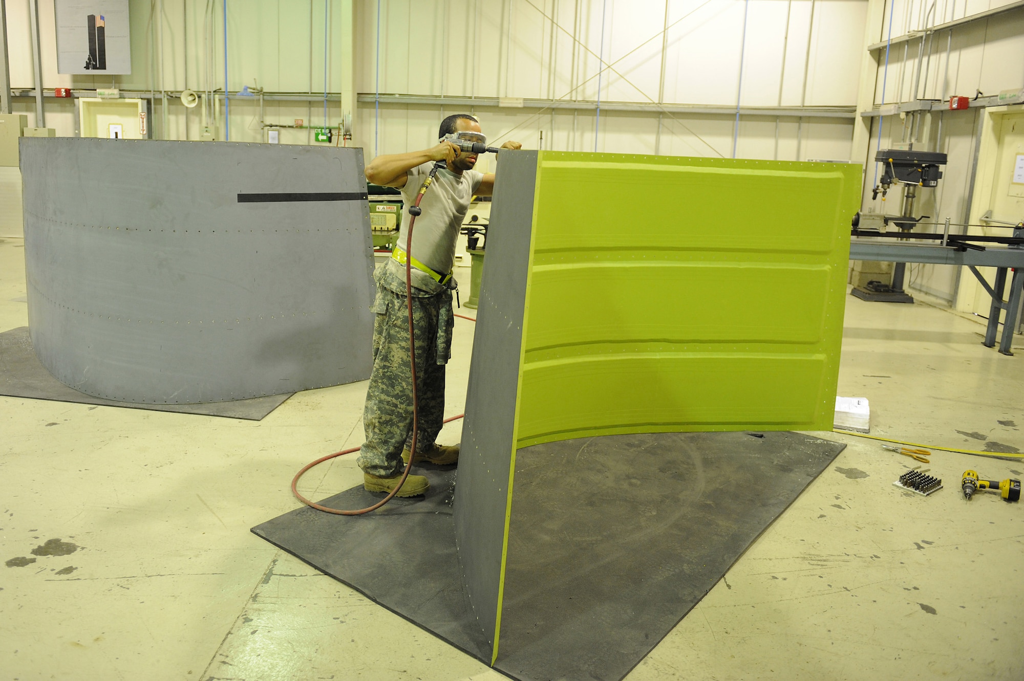 SOUTHWEST ASIA - Staff Sgt. Gary Pitcher, a 380th Expeditionary Maintenance Squadron, aircraft structural maintenance craftsman, drills counter sinking holes on a panel for a KC-10 Extender, June 17 at an undisclosed location in Southwest Asia. The holes will allow the screws to sit flush giving it an aerodynamic surface. (U.S. Air Force photo by Senior Airman Brian J. Ellis) (Released)