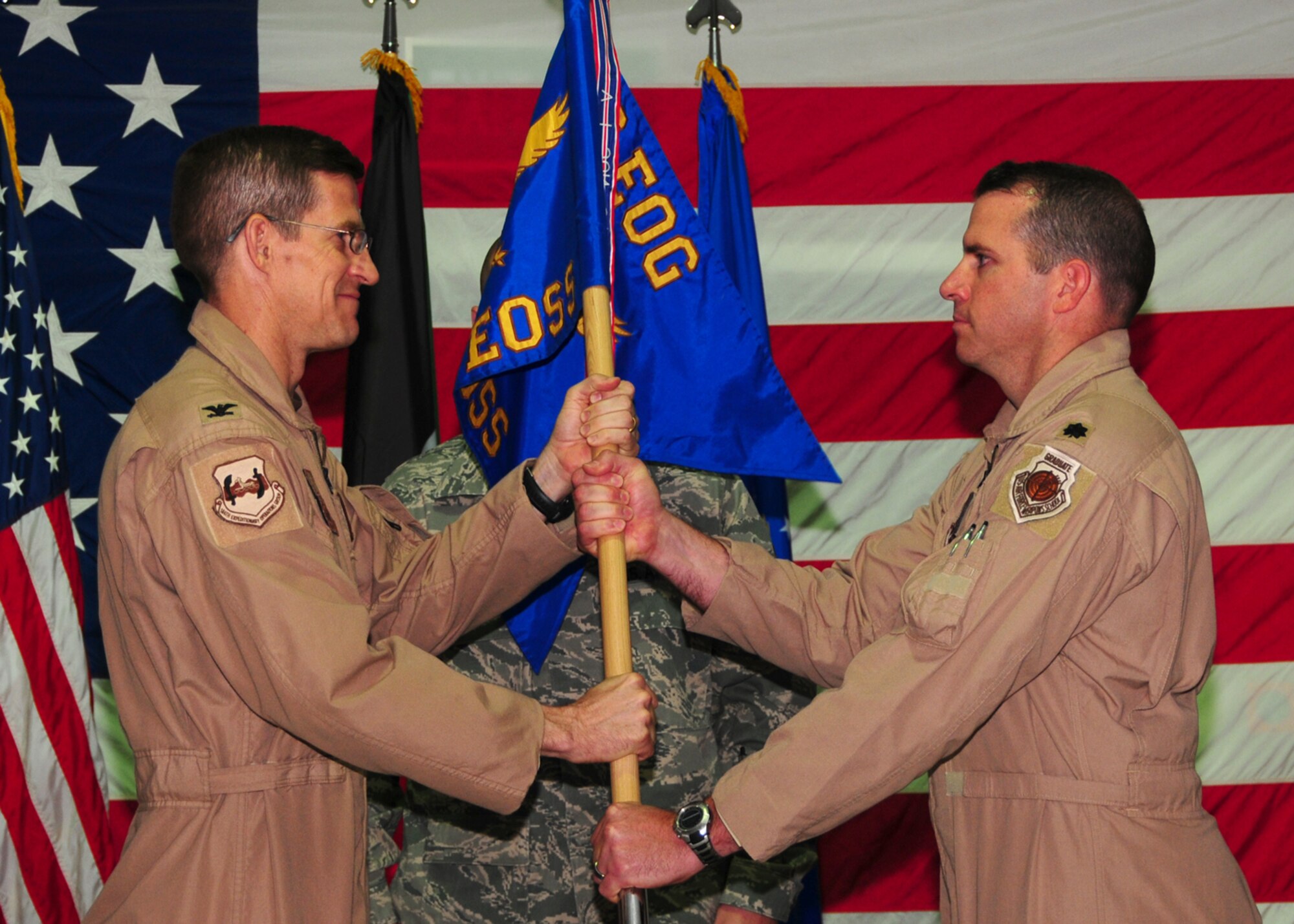SOUTHWEST ASIA -- Lt. Col. Charles Bolton receives command of the 386th Expeditionary Operations Support Squadron from Col. David Miller, 386th Expeditionary Operations Group commander, at an air base in Southwest Asia, July 1. (U.S. Air Force photo/Senior Airman Courtney Richardson)