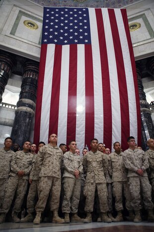 Marines from Multi National Force - West stand in front of a large American flag during a naturalization ceremony in Baghdad’s Al Faw palace, July 4, 2009. The ceremony was the largest to date in Iraq and was attended by the vice president of the United States, Joseph Biden, and commander of all coalition forces in Iraq, Gen. Ray Odierno, who both made speeches. (U.S. Marine Corps photograph by Cpl. Bobbie A. Curtis)