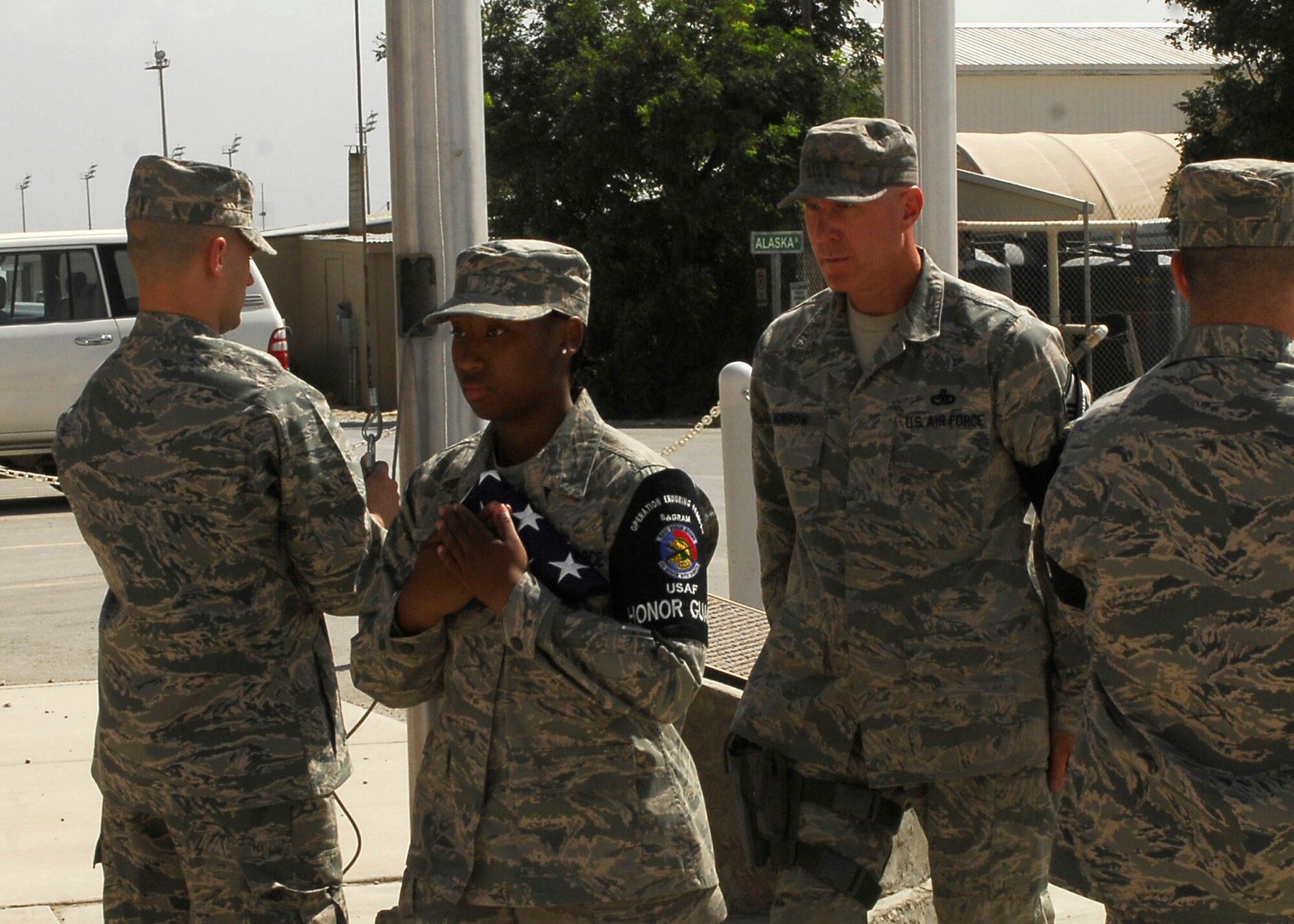 BAGRAM AIR FIELD, Afghanistan - Members of the Bagram Air Field Honor Guard raise multiple flags to commemorate the Fourth of July here. Bagram Air Field serves U.S. Air Forces Central and provides close air support, combat search rescue, aerial intelligence, surveillance and reconnaissance, and airlift capabilities to U.S. and coalition forces supporting Operation Enduring Freedom.(U.S. Air Force Photo by Senior Airman Felicia Juenke)