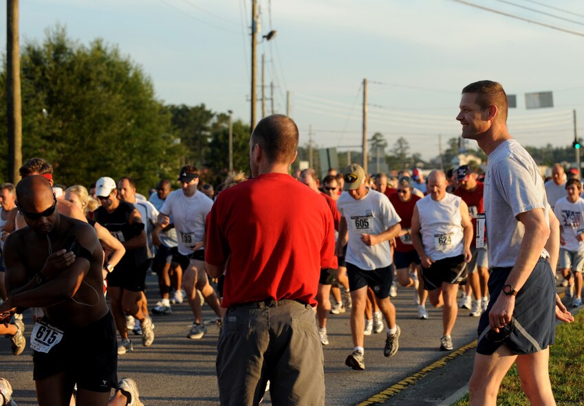 MOODY AIR FORCE BASE, Ga. -- Col. Gary Henderson, 23rd Wing commander, watches the field of runners pass by the starting line after kicking off the Independence Day 5k in Valdosta, Ga., July 4. (U.S. Air Force photo by Senior Airman Gina Chiaverotti)