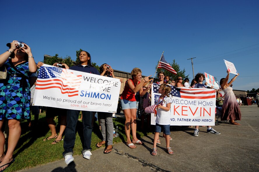 MOODY AIR FORCE BASE, Ga. -- Friends and family cheer as members of the 824th Security Forces Squadron march towards them here July 3. The 824th SFS just returned from a six-month deployment to Camp Bucca, Iraq. (U.S. Air Force photo by Senior Airman Gina Chiaverotti)