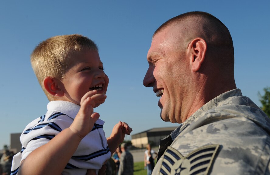 MOODY AIR FORCE BASE, Ga. -- Tech. Sgt. Justin Geers, 824th Security Forces Squadron, holds his son Austin for the first time in six months here July 3. Sergeant Geers just returned from a six-month deployment to Iraq. (U.S. Air Force photo by Senior Airman Gina Chiaverotti)
