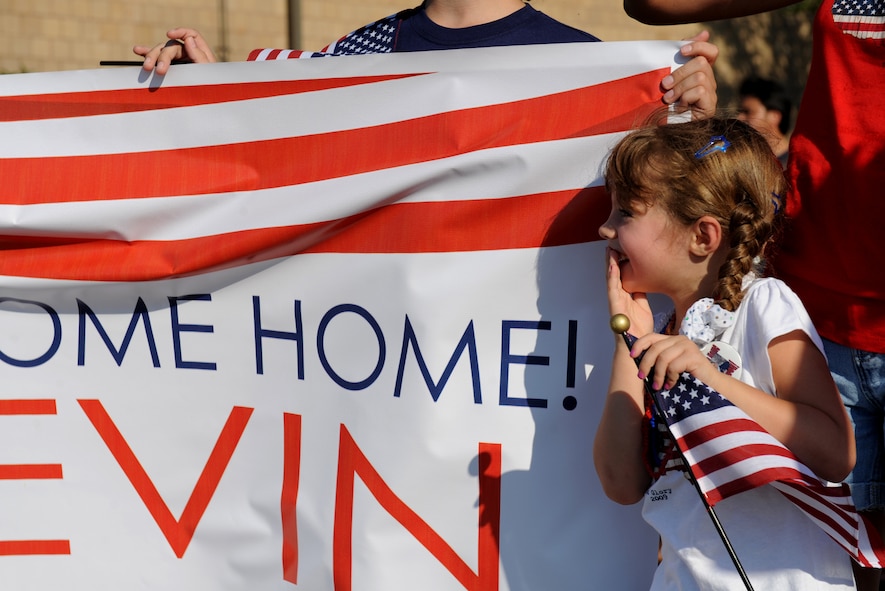 MOODY AIR FORCE BASE, Ga. -- Master Sgt. Kevin Olheiser's daughter holds in her emotion as she watches her father march forward at a homecoming here July 3. Sergeant Olheiser is the 824th Security Forces Squadron's first sergeant and just returned from a six-month deployment to Iraq. (U.S. Air Force photo by Senior Airman Gina Chiaverotti)
