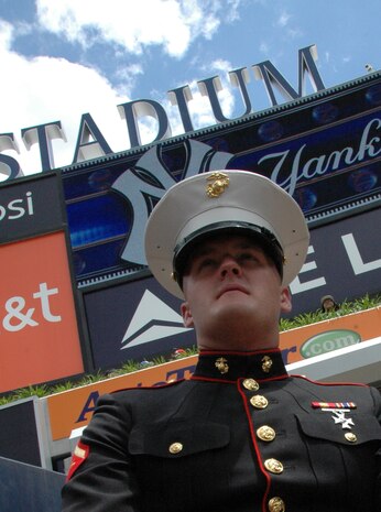 Lance Cpl. William Davison, Albany, Ga. Marine Corps Band  guitar player, stands at the entrance to Yankee Stadium, July 4. The band marched on the field and played the Canadian and American National Anthem before the New York Yankees vs Toronto Blue Jays baseball game at Yankee Stadium, New York City. The band plays for more than 250,000 people each year while touring the country. (Official Marine Corps photo by Sgt. Randall A. Clinton)
