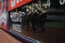 Marines from the Albany Marine Corps Band march onto the field before playing the Canadian and American National Anthem before the New York Yankees vs Toronto Blue Jays baseball game at Yankee Stadium, New York City, July 4. The band plays for more than 250,000 people each year while touring the country. (Official Marine Corps photo by Sgt. Randall A. Clinton)