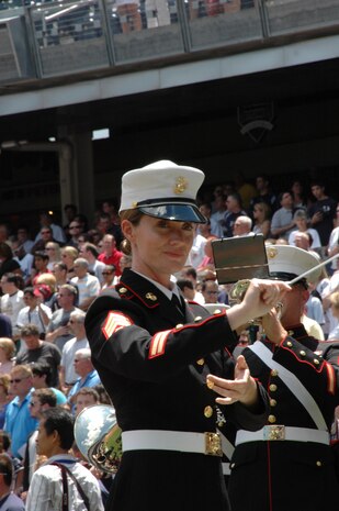 Staff Sgt. Kristine Streng, Albany Ga., Marine Corps Band, enlisted conductor, leads the band playing the National Anthem before the New York Yankees vs Toronto Blue Jays baseball game at Yankee Stadium, New York City, July 4. The band plays for more than 250,000 people each year while touring the country. (Official Marine Corps photo by Sgt. Randall A. Clinton)