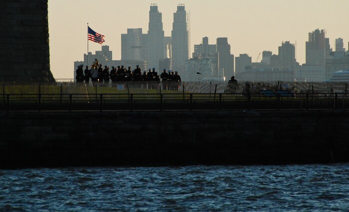 The Albany Marine Corps Band plays during the reopening ceremony for the Statue of Liberty crown and a naturalization ceremony for seven service members, July 4. The top of the statue had been closed since the terrorist attacks of 9/11. The band plays for more than 250,000 people each year while touring the country. (Official Marine Corps photo by Sgt. Randall A. Clinton)