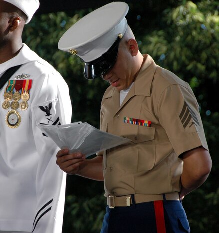 Sgt. Nilton Arrubla Torres, 1st Marine Corps Recruiting District, administrative clerk, along with six other service members, views his citizenship paperwork after completing their Oath of Citizenship during a ceremony on Liberty Island before the reopening of the Statue of Liberty's crown. The crown had been closed since the terrorist attacks of 9/11. (Official Marine Corps photo by Sgt. Randall A. Clinton)