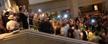 Press photographers and visitors attempt to capture the ribbon cutting at the base of the Statue of Liberty, July 4. The cutting ceremony officially reopened the crown for visitors after the terrorist attacks of 9/11. (Official Marine Corps photo by Sgt. Randall A. Clinton)