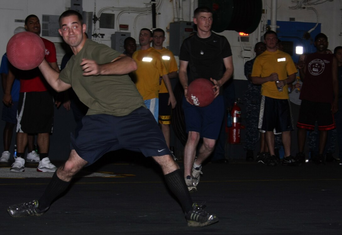 Marines from the 22nd Marine Expeditionary Unit and Sailors aboard the multi-purpose amphibious assault ship USS Bataan (LHD 5) compete in a dodge ball tournament in Bataan’s hangar bay July 4, 2009. The Marines and Sailors enjoyed a day of sporting events in celebration of Independence Day. Bataan is serving as the flagship of the Bataan Amphibious Ready Group (ARG), supporting Maritime Security Operations (MSO) in the U.S. 5th Fleet area of operations. The 22nd MEU, embarked aboard the ships of the Bataan Amphibious Ready Group, is currently serving as the theater reserve force for U.S. Central Command.::r::::n::(Official Marine Corps photo by Staff Sgt. Matt Epright)