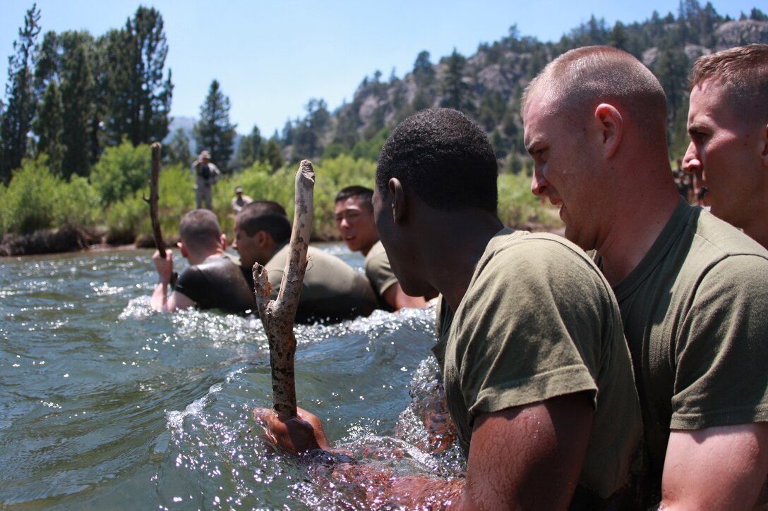 Naval Reserve Officer Training Corps midshipmen wade through icy waters at Mountain Warfare Training Center Bridgeport, Calif., Sunday when they learned to cross streams in mountainous terrain.