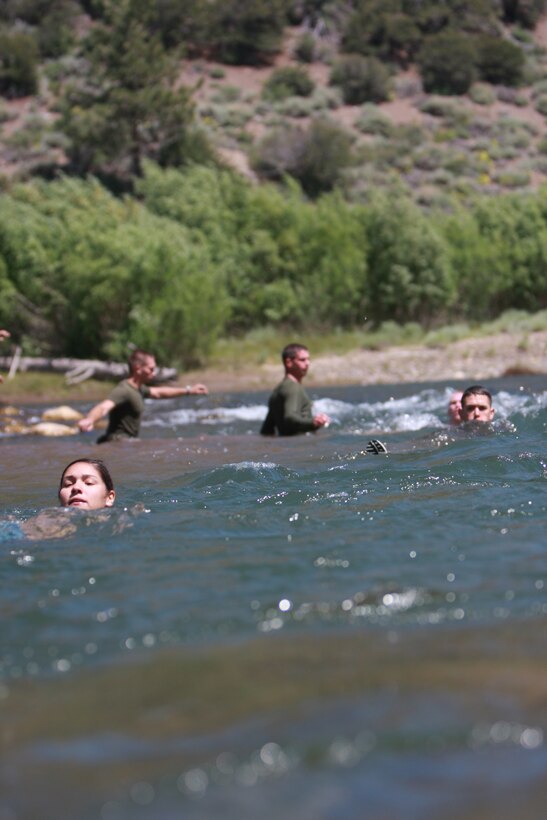 Naval Reserve Officer Training Corps midshipmen float down a stream july 5 at Mountain Warfare Training Center Bridgeport, Calif., when they learned to cross streams in mountainous terrain.